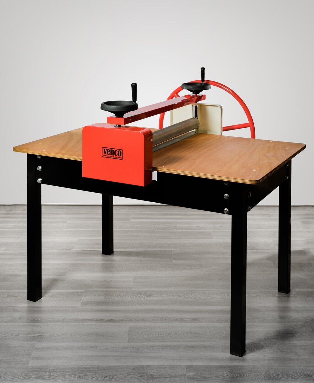 Metal frame table with timber top and slab roller machine