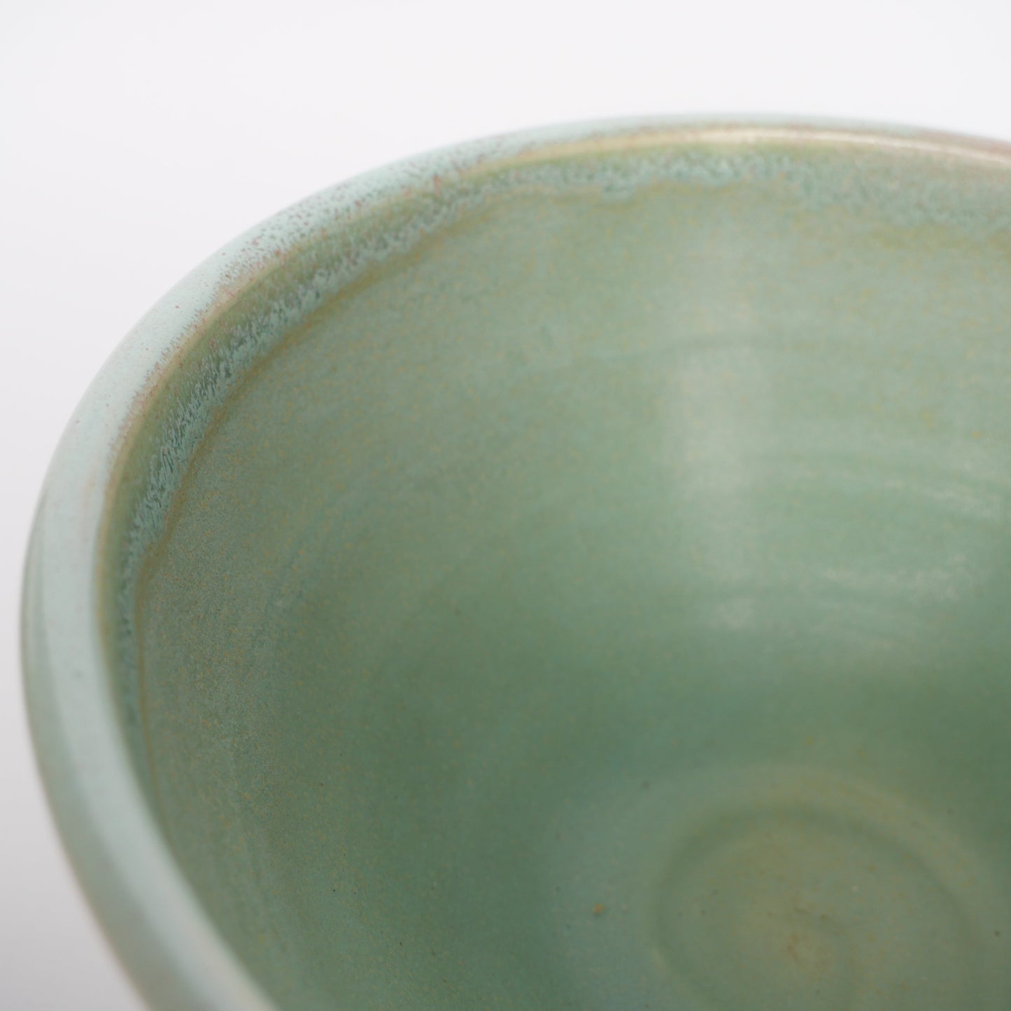Light green ceramic bowl on a white background